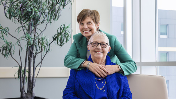 Stroke Gift Standing person hugging sitting person from behind